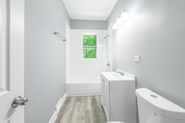 1310 E 72nd St, Chicago, IL 60619 - bathroom with vanity, wood finished floors, and  shower combination