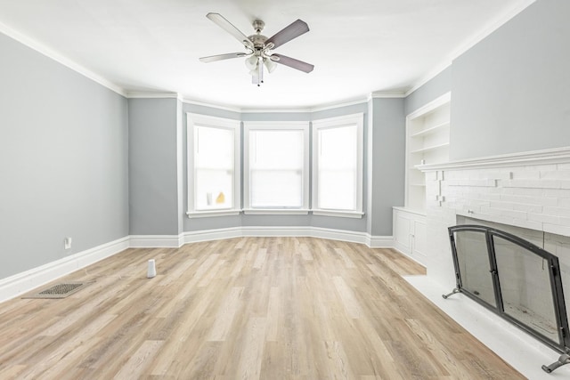 1310 E 72nd St, Chicago, IL 60619 - unfurnished living room with a ceiling fan, light wood finished floors, a fireplace, built in features, and ornamental molding