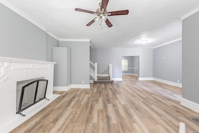 1310 E 72nd St, Chicago, IL 60619 - unfurnished living room featuring stairway, ornamental molding, light wood finished floors, a fireplace, and ceiling fan
