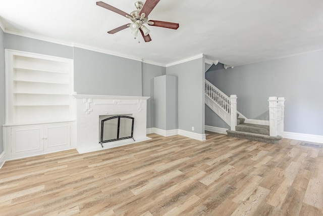 1310 E 72nd St, Chicago, IL 60619 - unfurnished living room featuring stairs, wood finished floors, a ceiling fan, crown molding, and a brick fireplace