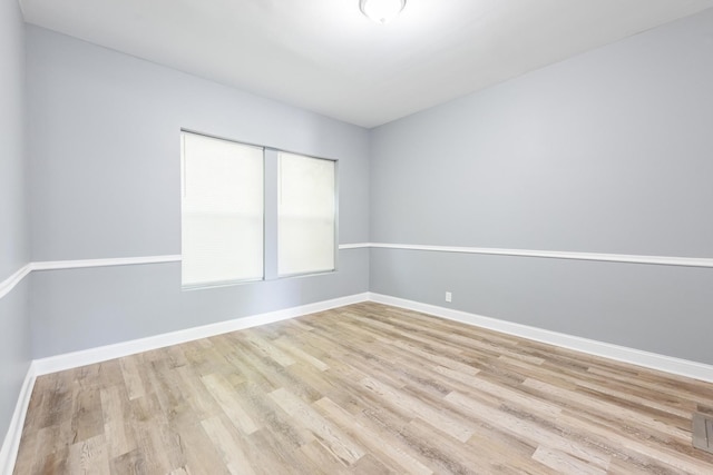 1310 E 72nd St, Chicago, IL 60619 - empty room featuring wood finished floors and baseboards