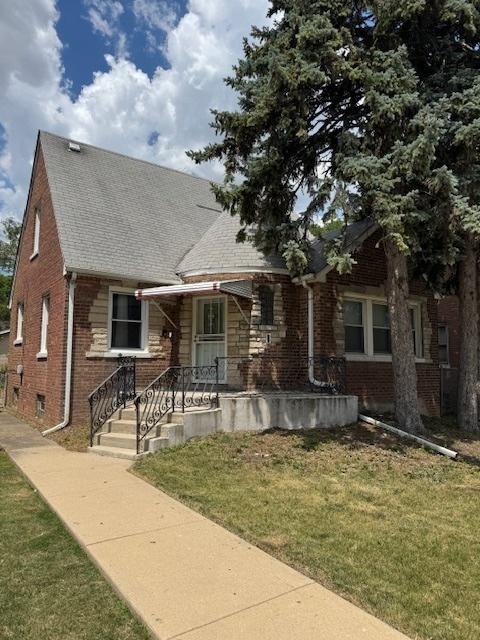 7604 S Campbell Ave, Chicago, IL 60652 - view of front facade with brick siding, a front yard, and a shingled roof
