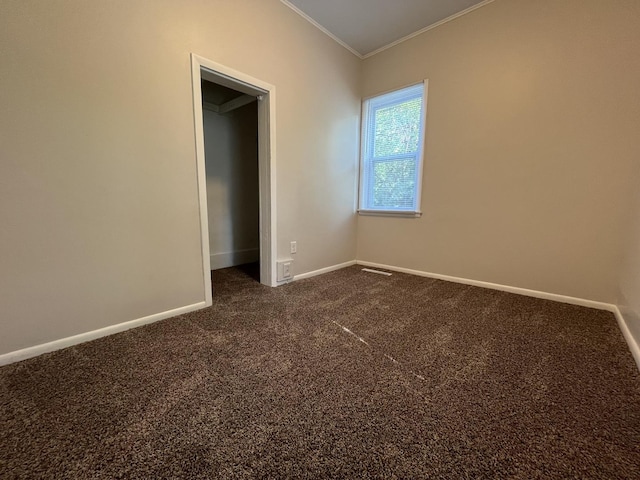 205 N Chicago St, Magnolia, IL 61336 - unfurnished bedroom featuring ornamental molding and dark carpet