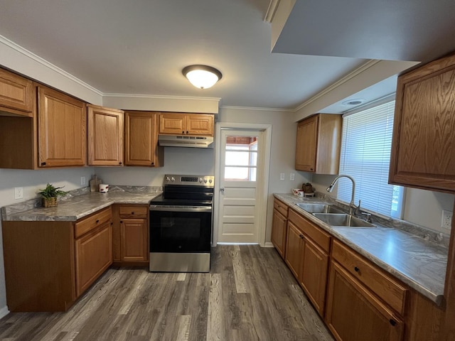 205 N Chicago St, Magnolia, IL 61336 - kitchen with stainless steel electric range, under cabinet range hood, dark wood finished floors, crown molding, and brown cabinetry