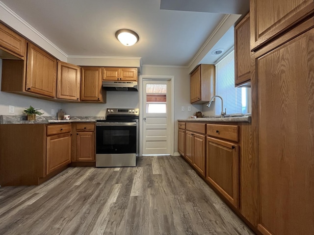 205 N Chicago St, Magnolia, IL 61336 - kitchen with stainless steel range with electric stovetop, under cabinet range hood, ornamental molding, dark wood finished floors, and brown cabinetry