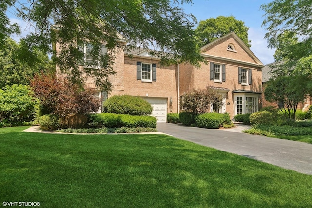 500 E Mayfair Rd, Arlington Heights, IL 60005 - view of front facade with concrete driveway, a front lawn, a garage, and brick siding