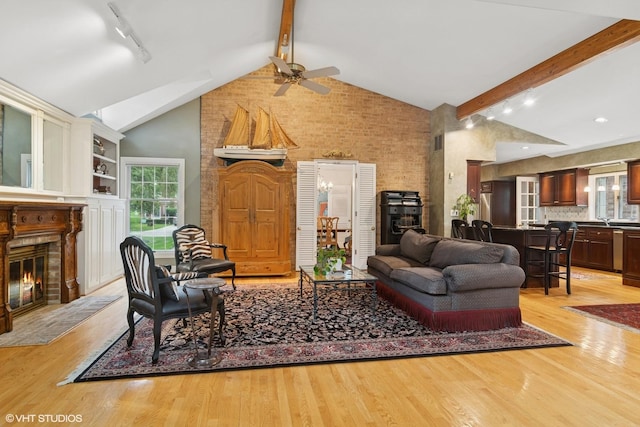 500 E Mayfair Rd, Arlington Heights, IL 60005 - living area featuring rail lighting, ceiling fan, beamed ceiling, a glass covered fireplace, and light wood-style floors