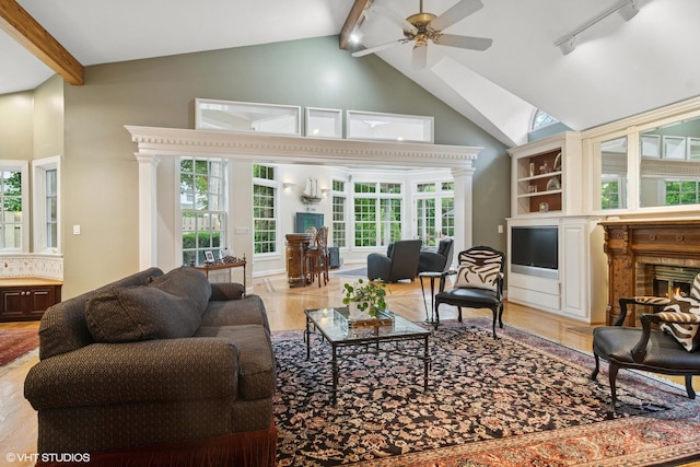 500 E Mayfair Rd, Arlington Heights, IL 60005 - living area featuring a glass covered fireplace, beam ceiling, ceiling fan, high vaulted ceiling, and healthy amount of natural light