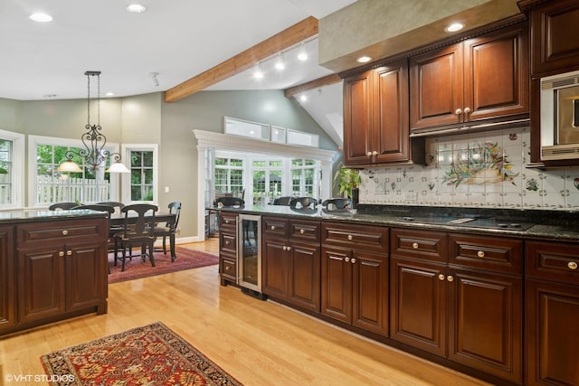 500 E Mayfair Rd, Arlington Heights, IL 60005 - kitchen with beverage cooler, black electric stovetop, backsplash, light wood-style floors, and decorative light fixtures