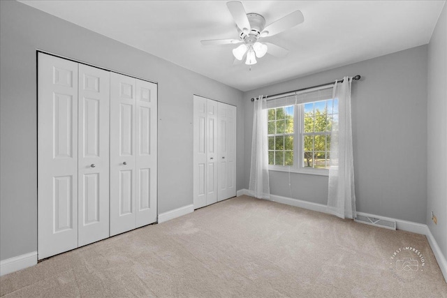 1519 Wedgefield Cir, Naperville, IL 60563 - unfurnished bedroom featuring multiple closets, carpet floors, and ceiling fan