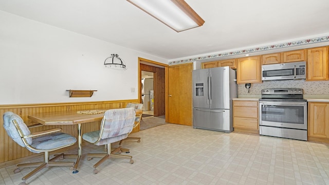 8033 S Pine St, Dixon, IL 61021 - kitchen featuring appliances with stainless steel finishes, wainscoting, light countertops, light flooring, and light brown cabinets