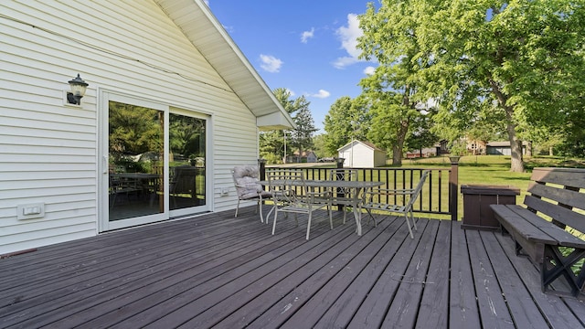 8033 S Pine St, Dixon, IL 61021 - deck featuring outdoor dining space, a lawn, and a storage unit