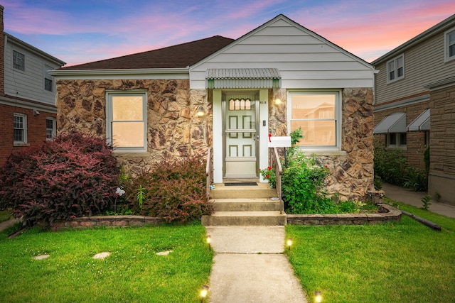 4308 N Ozark Ave, Norridge, IL 60706 - view of front of home with a yard, stone siding, and a shingled roof