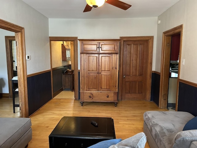 7246 N Oleander Ave, Chicago, IL 60631 - living room featuring light wood finished floors, ceiling fan, and wainscoting