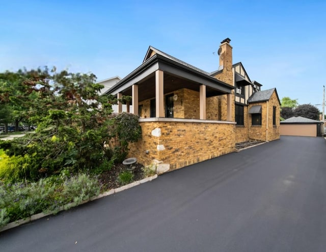 7246 N Oleander Ave, Chicago, IL 60631 - view of side of property featuring a chimney and brick siding