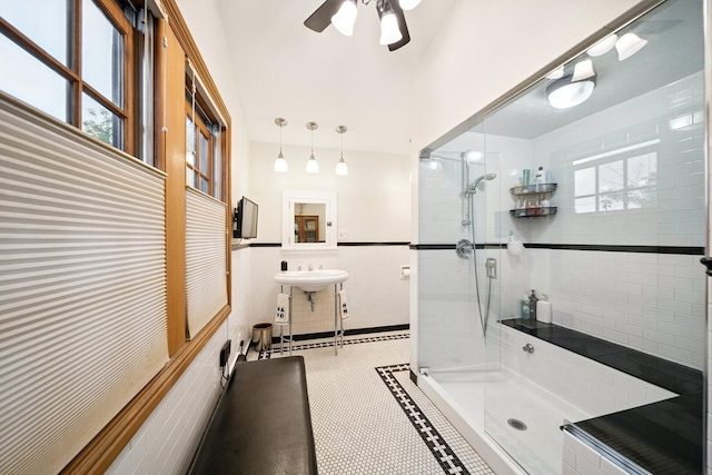 7246 N Oleander Ave, Chicago, IL 60631 - full bathroom featuring a tile shower, tile walls, a ceiling fan, and wainscoting