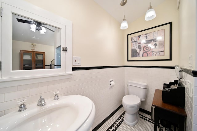 7246 N Oleander Ave, Chicago, IL 60631 - half bathroom with lofted ceiling, tile walls, tile patterned flooring, and a wainscoted wall