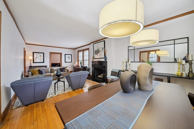 7246 N Oleander Ave, Chicago, IL 60631 - dining room featuring a tile fireplace, wood-type flooring, and ornamental molding