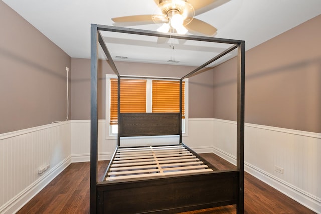 12300 Maple Ave, Blue Island, IL 60406 - unfurnished bedroom with a wainscoted wall, wood finished floors, and a ceiling fan