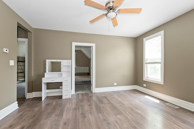 12300 Maple Ave, Blue Island, IL 60406 - unfurnished bedroom with wood finished floors and a ceiling fan