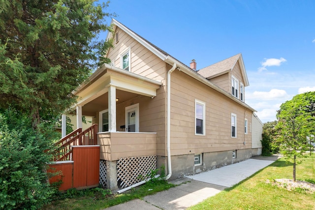 12300 Maple Ave, Blue Island, IL 60406 - view of home's exterior with a chimney and covered porch