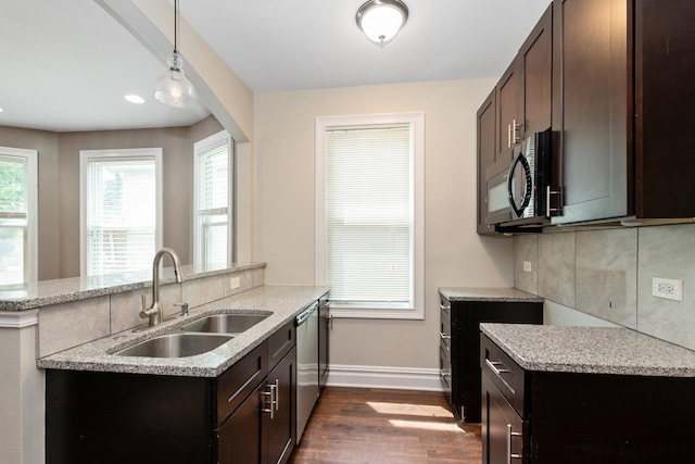 12300 Maple Ave, Blue Island, IL 60406 - kitchen with black microwave, dark wood-type flooring, dark brown cabinets, stainless steel dishwasher, and light stone countertops
