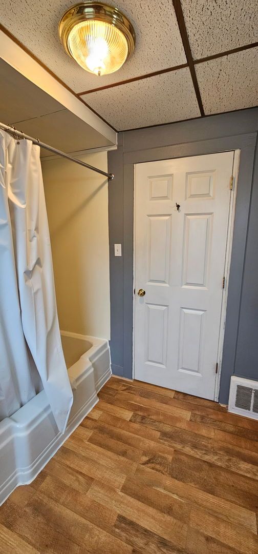 24 Mulberry St, Savanna, IL 61074 - entryway featuring wood finished floors and a drop ceiling