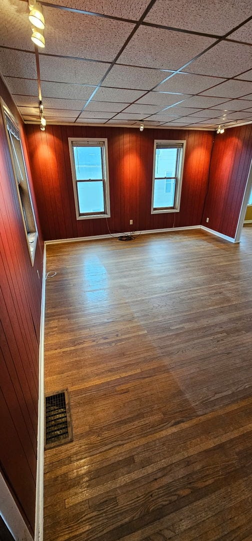 24 Mulberry St, Savanna, IL 61074 - unfurnished room featuring wood-type flooring and wood walls