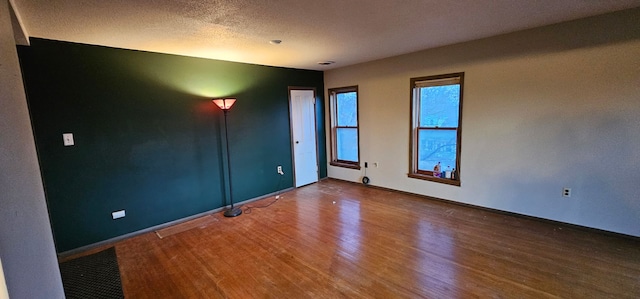 24 Mulberry St, Savanna, IL 61074 - spare room with wood finished floors and a textured ceiling