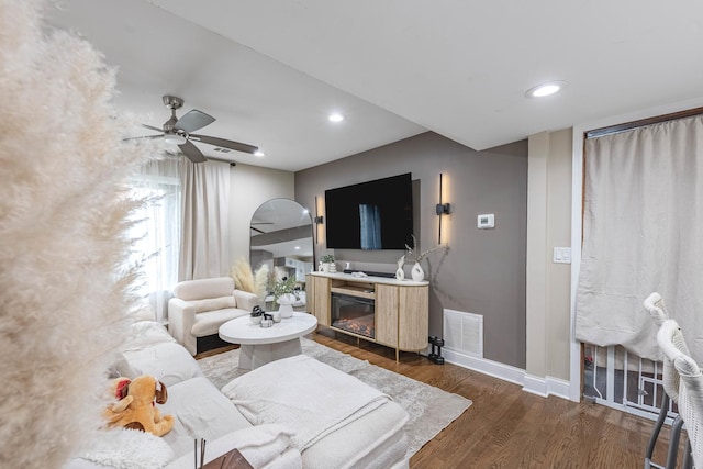 4918 S Luna Ave, Chicago, IL 60638 - living room with dark wood-style flooring, ceiling fan, a glass covered fireplace, and recessed lighting