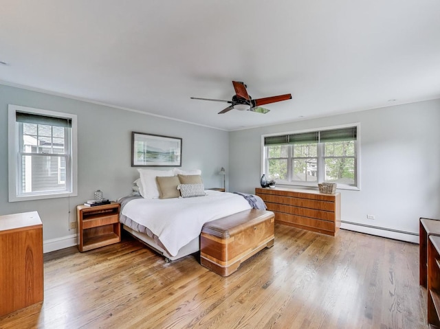125 Thatcher Ave, River Forest, IL 60305 - bedroom with baseboard heating, light wood-style flooring, a ceiling fan, and crown molding