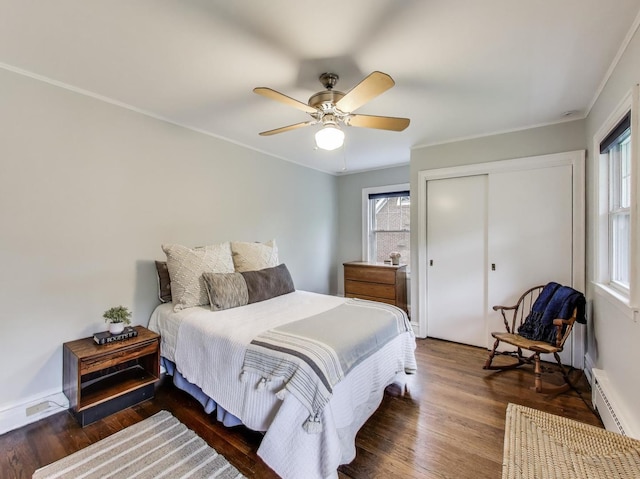 125 Thatcher Ave, River Forest, IL 60305 - bedroom with baseboard heating, wood finished floors, multiple windows, a closet, and crown molding