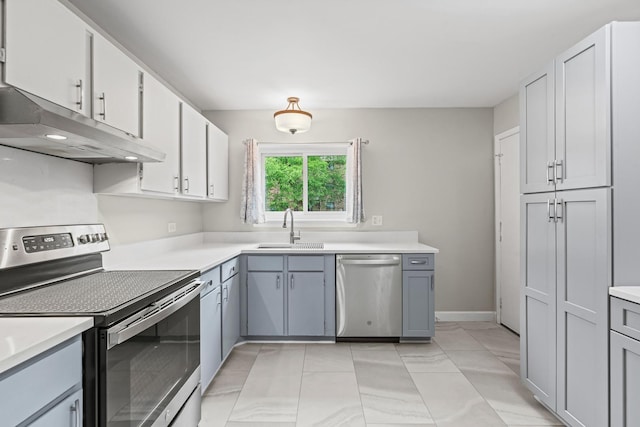 2215 Nichols Rd Unit B, Arlington Heights, IL 60004 - kitchen featuring stainless steel appliances, under cabinet range hood, light countertops, white cabinetry, and gray cabinetry