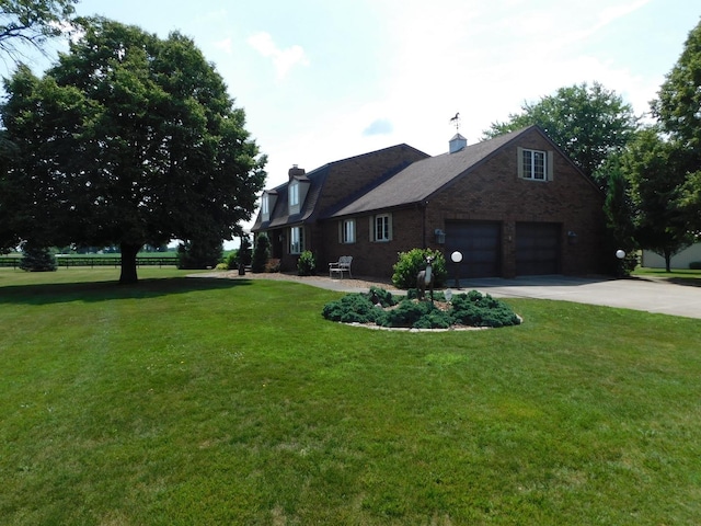 10766 E 7000n Rd, Grant Park, IL 60940 - view of front of house with concrete driveway, a front yard, a chimney, and brick siding