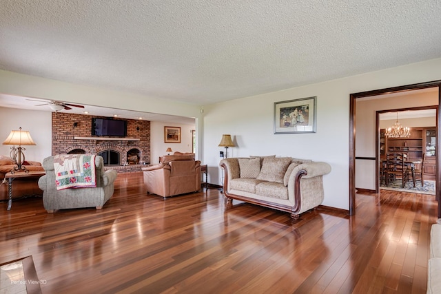 10766 E 7000n Rd, Grant Park, IL 60940 - living room featuring a chandelier, dark wood-type flooring, a textured ceiling, a fireplace, and ceiling fan