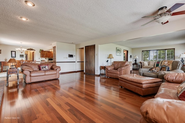 10766 E 7000n Rd, Grant Park, IL 60940 - living room featuring a chandelier, a ceiling fan, a textured ceiling, and wood finished floors