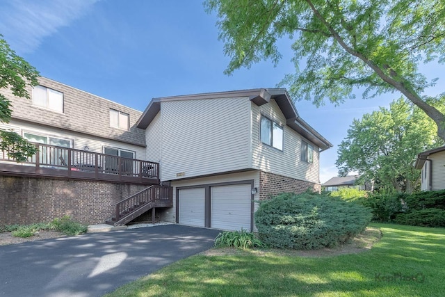 29W400 Thornwood Ln, Warrenville, IL 60555 - rear view of property with asphalt driveway, brick siding, an attached garage, stairs, and a yard