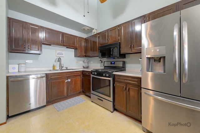 29W400 Thornwood Ln, Warrenville, IL 60555 - kitchen featuring stainless steel appliances, light countertops, dark brown cabinetry, and light floors