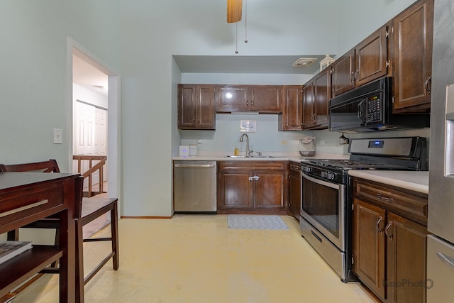 29W400 Thornwood Ln, Warrenville, IL 60555 - kitchen with stainless steel appliances, light countertops, a ceiling fan, and dark brown cabinets