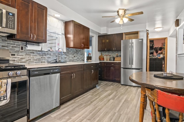 116 S Harold Ave, Northlake, IL 60164 - kitchen featuring appliances with stainless steel finishes, a ceiling fan, light countertops, tasteful backsplash, and dark brown cabinetry