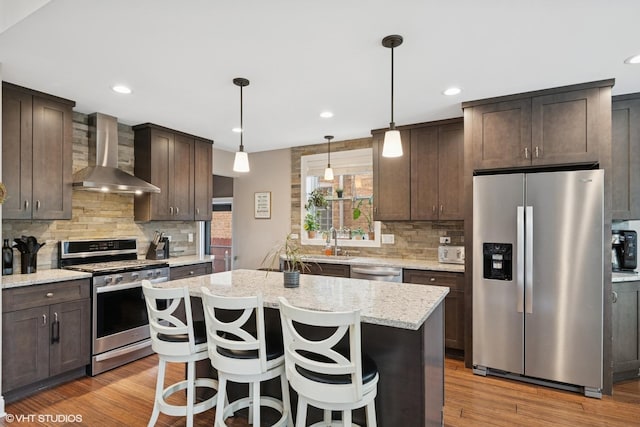 3109 N Oketo Ave, Chicago, IL 60707 - kitchen featuring stainless steel appliances, wall chimney range hood, dark brown cabinets, decorative backsplash, and recessed lighting
