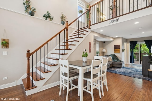 3109 N Oketo Ave, Chicago, IL 60707 - dining space with wood finished floors, stairway, a towering ceiling, and recessed lighting