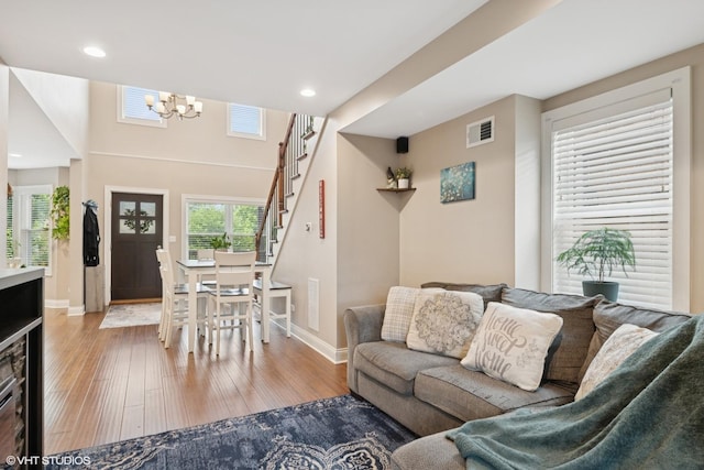 3109 N Oketo Ave, Chicago, IL 60707 - living room featuring wood-type flooring, stairs, a chandelier, and recessed lighting