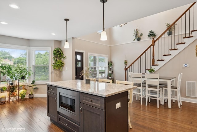 3109 N Oketo Ave, Chicago, IL 60707 - kitchen featuring stainless steel microwave, dark wood finished floors, recessed lighting, decorative light fixtures, and dark brown cabinets
