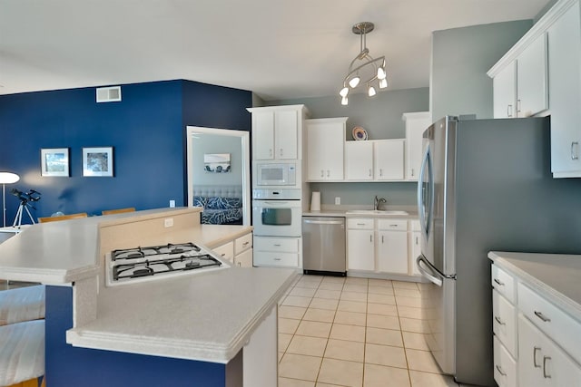 930 Candlewick Dr NE, Poplar Grove, IL 61065 - kitchen with appliances with stainless steel finishes, light countertops, light tile patterned floors, and white cabinets