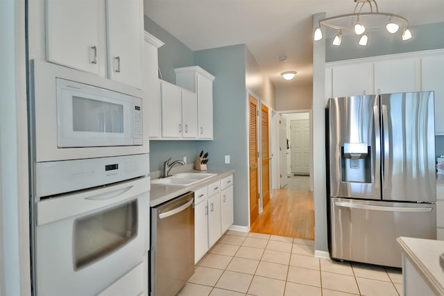 930 Candlewick Dr NE, Poplar Grove, IL 61065 - kitchen featuring stainless steel appliances, light countertops, light tile patterned flooring, and white cabinetry