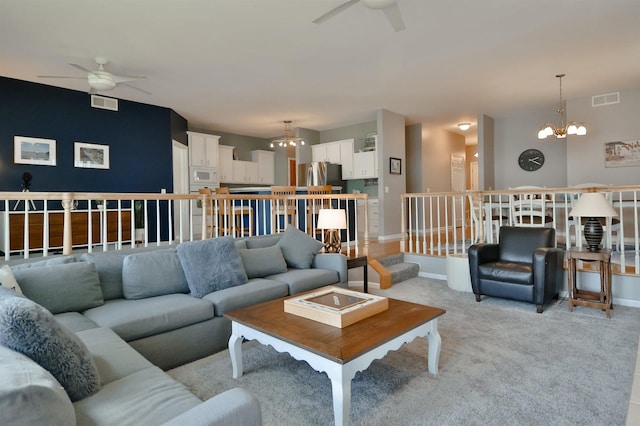 930 Candlewick Dr NE, Poplar Grove, IL 61065 - living room featuring a ceiling fan, a chandelier, and light colored carpet