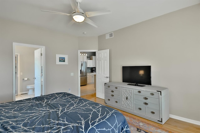 930 Candlewick Dr NE, Poplar Grove, IL 61065 - bedroom with stainless steel fridge, light wood-style floors, connected bathroom, and a ceiling fan