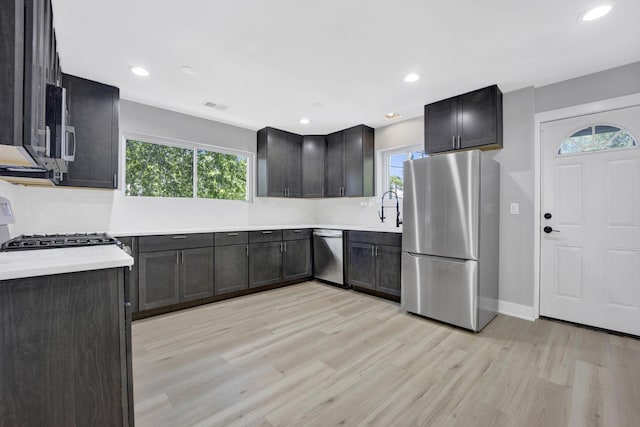 27W180 Cooley Ave, Winfield, IL 60190 - kitchen with appliances with stainless steel finishes, light wood-style flooring, plenty of natural light, light countertops, and recessed lighting