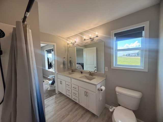 3938 Summer Sage Ct, Champaign, IL 61822 - bathroom featuring wood finished floors and double vanity